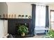 Living room with a modern fireplace, decorative mantel, and natural light from nearby windows at 19044 E 16Th Ave, Aurora, CO 80011