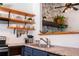 Stylish kitchen with open shelving, granite countertops, and modern appliances at 19044 E 16Th Ave, Aurora, CO 80011