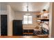 Bright kitchen featuring open wooden shelves, a modern refrigerator, and granite countertops at 19044 E 16Th Ave, Aurora, CO 80011