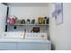 Functional laundry room with modern washer and dryer setup and organized shelving at 19044 E 16Th Ave, Aurora, CO 80011
