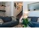 Cozy living room featuring stylish decor, comfortable seating, and a staircase leading to the upper level at 19044 E 16Th Ave, Aurora, CO 80011