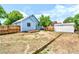 Spacious backyard with deck, fence, storage shed, grass and partial view of the house at 4556 S Pagosa Way, Aurora, CO 80015