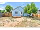 Charming backyard with a small deck and a blue house at 4556 S Pagosa Way, Aurora, CO 80015