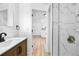 Modern bathroom showcasing elegant vanity, toilet and glass door shower with marble wall tiles at 4556 S Pagosa Way, Aurora, CO 80015