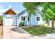Charming light blue one-story home featuring a one-car garage and well-maintained front yard at 4556 S Pagosa Way, Aurora, CO 80015