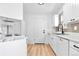 Bright, renovated kitchen with stainless steel appliances, white cabinetry, and marble-style countertops at 4556 S Pagosa Way, Aurora, CO 80015