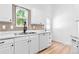 Updated kitchen featuring a stainless steel sink, sleek marble countertops and white cabinetry at 4556 S Pagosa Way, Aurora, CO 80015