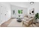 Bright living room with neutral tones and modern decor, perfect for relaxing and entertaining at 4556 S Pagosa Way, Aurora, CO 80015