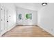 Bright, open-concept living room with wood floors and large window offering plenty of natural light at 4556 S Pagosa Way, Aurora, CO 80015