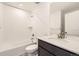 Bright bathroom featuring a tiled shower-tub, stone counter, and modern fixtures at 39877 Floyd St, Elizabeth, CO 80107