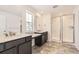 Modern bathroom with double vanity, granite countertops, tiled floor, and a glass door shower at 39877 Floyd St, Elizabeth, CO 80107