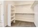 Walk-in closet with carpeted flooring, shelving, and metal hanging rods at 39877 Floyd St, Elizabeth, CO 80107