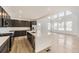 Bright kitchen with stainless appliances, a large island, and an open floor plan, with hardwood floors at 39877 Floyd St, Elizabeth, CO 80107