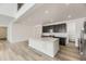 Modern kitchen with quartz countertops, a large island, stainless steel appliances, and hardwood floors at 39877 Floyd St, Elizabeth, CO 80107