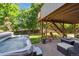 Inviting backyard featuring a hot tub, patio seating, and stairs leading to an upper deck at 735 Poppy Pl, Highlands Ranch, CO 80129
