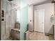 Bright bathroom showcasing a glass shower enclosure, decorative tiles, and pebble shower floor at 735 Poppy Pl, Highlands Ranch, CO 80129