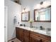 Bathroom featuring double sinks with wood cabinets and granite countertops at 735 Poppy Pl, Highlands Ranch, CO 80129