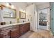 Bright bathroom boasts wood cabinets, granite counters, and dual sinks at 735 Poppy Pl, Highlands Ranch, CO 80129