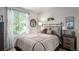 Comfortable bedroom with neutral decor, a queen bed, and decorative wall art at 735 Poppy Pl, Highlands Ranch, CO 80129