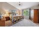 Tranquil bedroom featuring vaulted ceilings, a comfortable bed, and a large window overlooking the backyard at 735 Poppy Pl, Highlands Ranch, CO 80129
