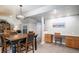 Open dining area boasts a large wooden table, chandelier, and a functional desk space at 735 Poppy Pl, Highlands Ranch, CO 80129