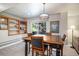 Dining area featuring a wooden table, with four chairs, and built-in shelving at 735 Poppy Pl, Highlands Ranch, CO 80129