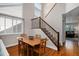 Cozy dining area featuring hardwood floors, a staircase, and large windows for ample natural light at 735 Poppy Pl, Highlands Ranch, CO 80129