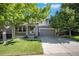Charming two-story home with a well-maintained front yard and inviting porch, shaded by mature trees at 735 Poppy Pl, Highlands Ranch, CO 80129