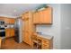 Kitchen featuring stainless steel appliances, wood cabinets, a desk, and wood floors at 735 Poppy Pl, Highlands Ranch, CO 80129