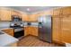 Kitchen featuring stainless steel appliances and wood cabinets, and grey countertops at 735 Poppy Pl, Highlands Ranch, CO 80129