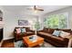 Cozy living room featuring a fireplace and large windows, offering a comfortable and inviting atmosphere at 735 Poppy Pl, Highlands Ranch, CO 80129