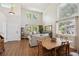 Bright living room featuring high ceilings, large windows, hardwood floors, and a comfortable seating area at 735 Poppy Pl, Highlands Ranch, CO 80129
