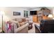 Cozy living room with comfortable seating, built-in shelving, and a mounted television at 735 Poppy Pl, Highlands Ranch, CO 80129