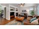Inviting living room with a fireplace, built-in shelving, and a large window overlooking the yard at 735 Poppy Pl, Highlands Ranch, CO 80129