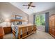 Main bedroom featuring vaulted ceiling, ceiling fan, large window, and a wooden bedframe at 735 Poppy Pl, Highlands Ranch, CO 80129