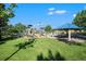 Community playground with picnic tables under a shaded pavilion and a grassy lawn at 735 Poppy Pl, Highlands Ranch, CO 80129