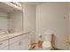Well-lit bathroom with granite countertop vanity and tiled flooring, adjacent to a toilet at 13025 Umatilla Ct, Denver, CO 80234