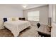 Bright bedroom features a ceiling fan, plush carpet, and a large window for natural light at 13025 Umatilla Ct, Denver, CO 80234