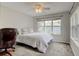 Carpeted bedroom with a large window providing ample light and view, complete with ceiling fan at 13025 Umatilla Ct, Denver, CO 80234