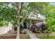 Charming home with a cozy front porch, mature landscaping, and a well-maintained lawn at 13025 Umatilla Ct, Denver, CO 80234