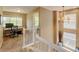 Upstairs hallway leads to an office space and features a window seat with a decorative chandelier at 13025 Umatilla Ct, Denver, CO 80234