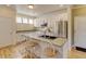 Bright kitchen with white cabinets, stainless steel appliances, and a breakfast bar at 13025 Umatilla Ct, Denver, CO 80234