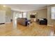 Bright and airy living room with hardwood floors, comfortable seating, and dining area at 13025 Umatilla Ct, Denver, CO 80234