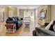 Spacious living room with hardwood floors, comfortable seating, and dining area at 13025 Umatilla Ct, Denver, CO 80234