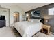 Main bedroom features an ensuite bath, modern colors, and natural light at 13025 Umatilla Ct, Denver, CO 80234