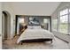 Spacious main bedroom boasts two windows, modern lighting and calming color palette at 13025 Umatilla Ct, Denver, CO 80234