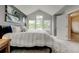 Sun-filled main bedroom featuring vaulted ceilings, neutral tones, and plush carpet at 13025 Umatilla Ct, Denver, CO 80234