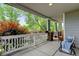 Spacious porch with comfortable seating and views of lush greenery at 13025 Umatilla Ct, Denver, CO 80234