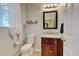 Well-maintained powder room with modern fixtures, vanity, and a decorative mirror at 13025 Umatilla Ct, Denver, CO 80234