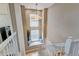 Bright staircase with decorative chandelier and sitting area at 13025 Umatilla Ct, Denver, CO 80234
